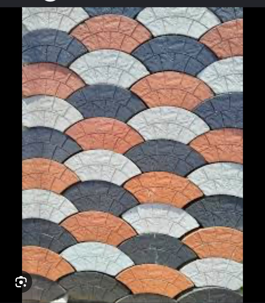 Laid fan-shaped circular pavers in orange, grey and charcoal forming a scalloped pattern