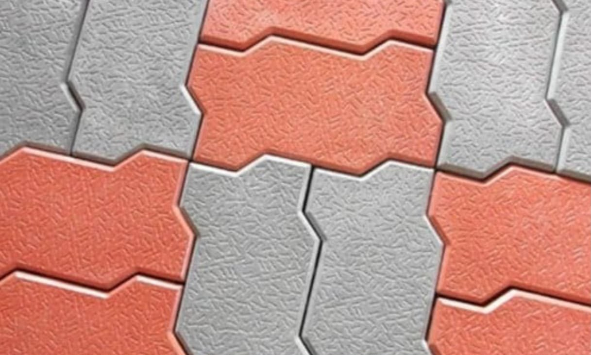 Laid zig-zag interlocking paver blocks in red and grey